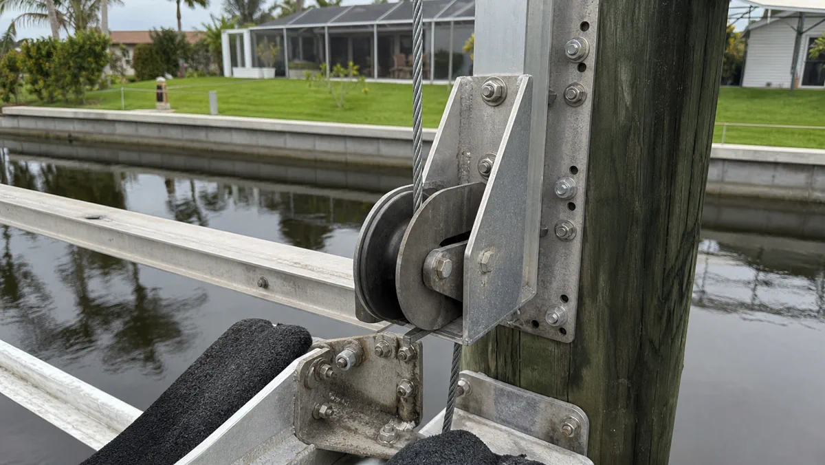 Boat lift repair detail showing dock-side parts and hardware